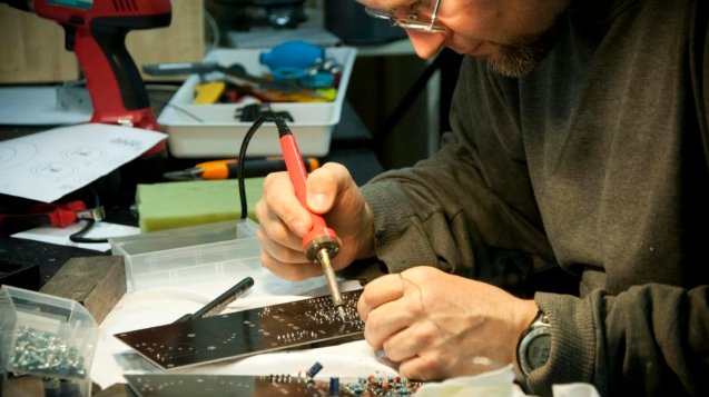 Man Soldering Circuit Board